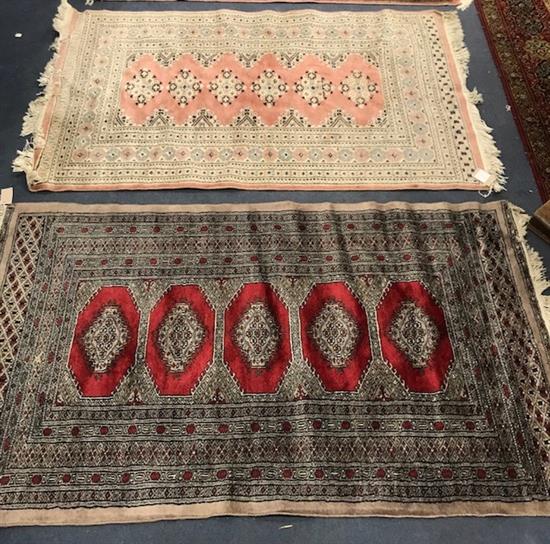 A Pakistan Bokhara rug, woven with five lozenge filled medallions, 158 x 94 cm, together with a pink ground rug, 150 x 100cm 150 x 99cm